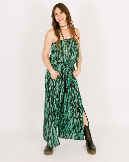 Strapless green jumpsuit with a black tie dye pattern, and long pants