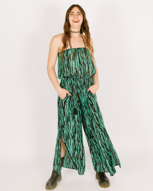 Strapless green jumpsuit with a black tie dye pattern, and long pants