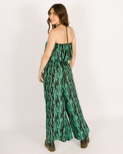 Strapless green jumpsuit with a black tie dye pattern, and long pants