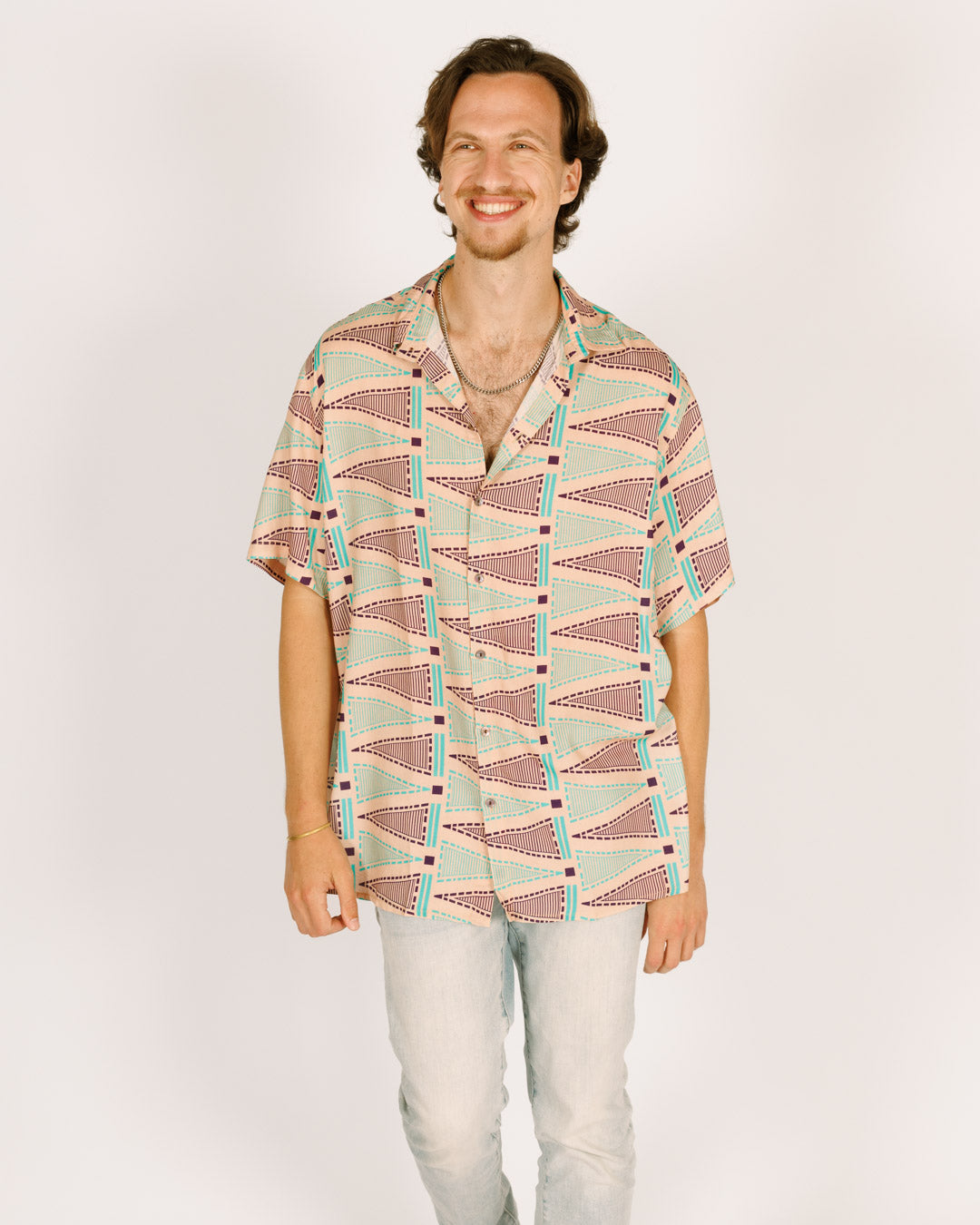 Short viscose button-up shirt for men - pink with triangular patterns in blue